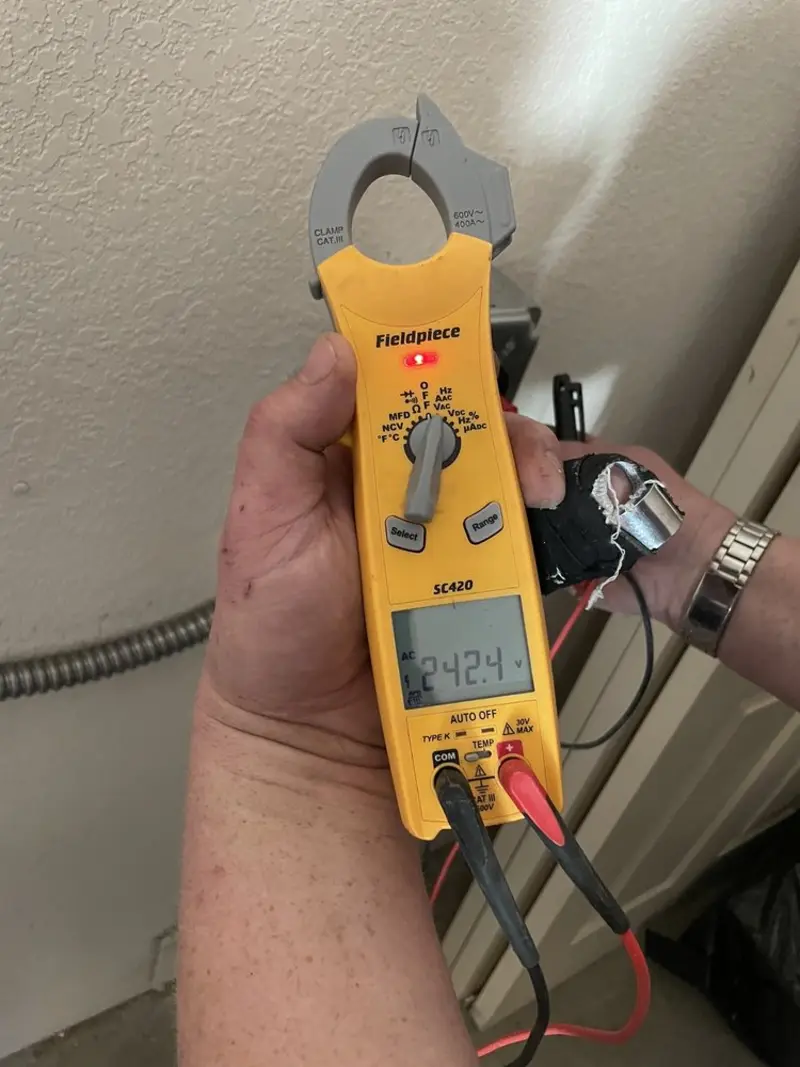 Voltage testing with clamp meter during Whole House Surge Protector in Gas City
